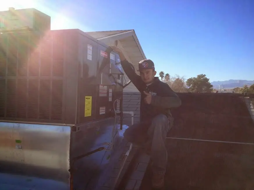 HVAC technician performing HVAC Inspection on a rooftop unit in Ilchester
